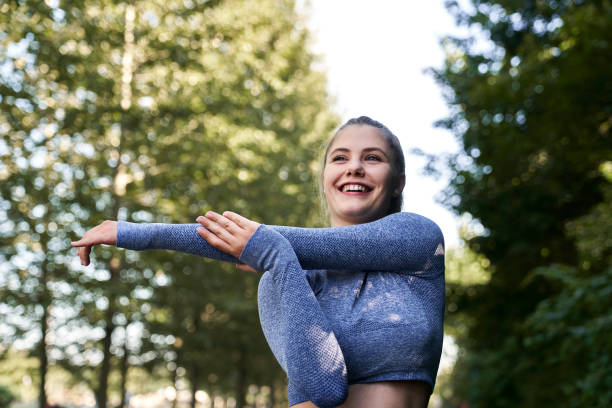istock Young woman stretching before running in the park 2022471525