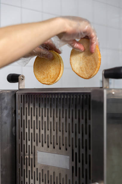 istock Conveyor toaster for frying burger buns 2022482216