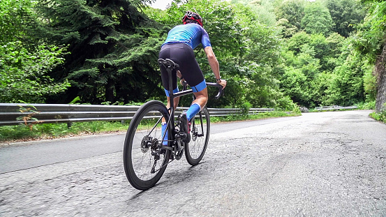 cyclist leads in action,Front view man riding bicycle in the racing road