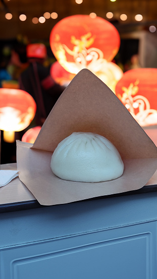 a wrapped baozi on the counter of a Chinese restaurant