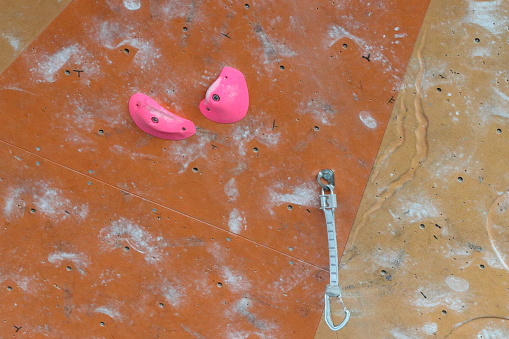 boys during a climbing competition with rope and harness in the gym with colored blocks