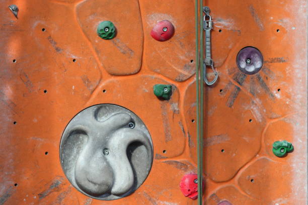 A climbing wall is an artificially constructed wall with manufactured grips (or \
