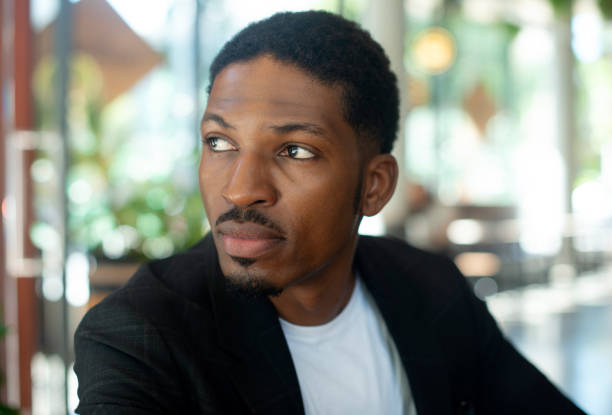Man, cafe and vision for planning, thinking and ideas for brainstorming and solutions. African person, face and daydreaming for problem solving, inspiration and decisions for future work or vacation