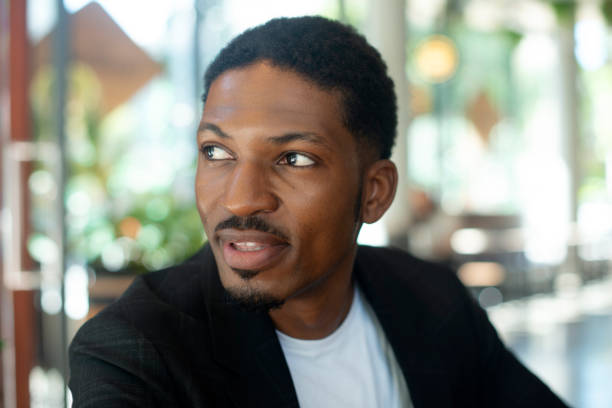 Black man, smile and looking away with planning, thinking and dreaming of ideas for future. African male person, flawless skin and glow with questions, solutions and vision of grooming or skincare