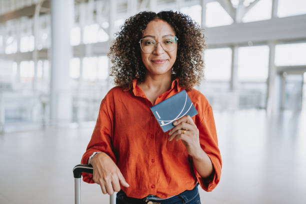 istock Portrait woman showing passport 2022565662