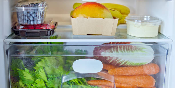 fridge stocked with fresh vegetables and fruit - refrigerator healthy eating mango fruit stock-fotos und bilder