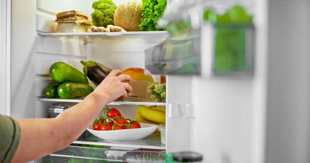 istock Woman hands taking mango out of refrigerator 2022570689
