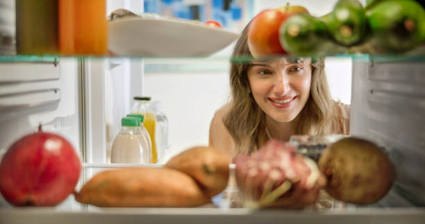 istock Woman looking vegetable food in refrigerator 2022572225