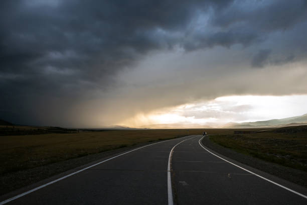 istock road mountains clouds storm sunlight sunset 2022582086