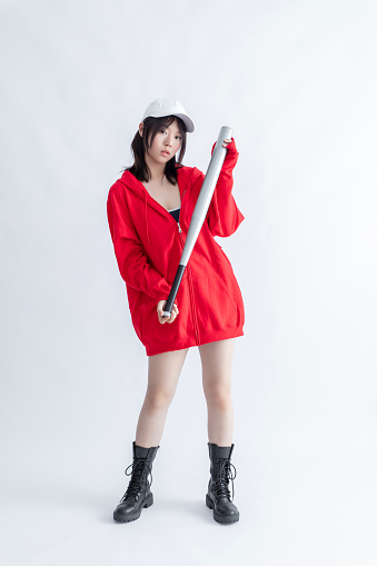 Asian woman in red hoodie holding a baseball bat