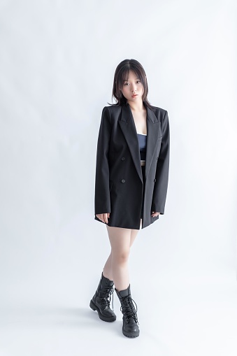 Asian woman in black suit and boots