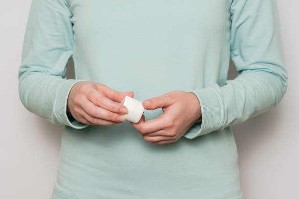 istock Plastic jar (container) in a woman's hands. Cosmetic product. 2022624643