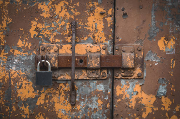 istock old rusty door with lock and padlock in different colors, abstraction 2022626402
