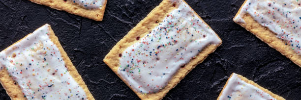 istock Pop tarts panorama. Poptart toaster pastry on a black background, overhead 2022631432