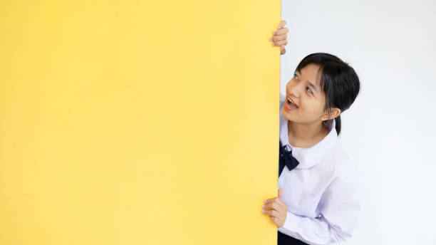 happy student young girl with yellow billbord. - billbord photos et images de collection