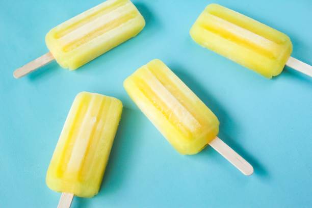 istock yellow ice cream sticks, on a blue background 2022668528