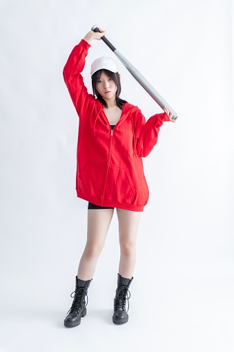 Asian woman in red hoodie holding a baseball bat
