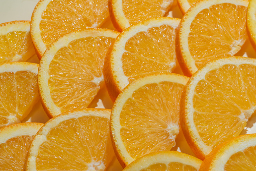 Sliced ripe oranges as a food background. Exotic fruits.