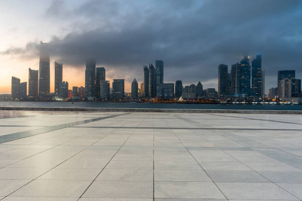 istock mpty concrete square with modern cityscape during sunrise. copy space for parking lot. 2022678072