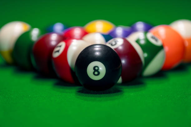 istock Many colorful billiard balls and cue on green table 2022679260