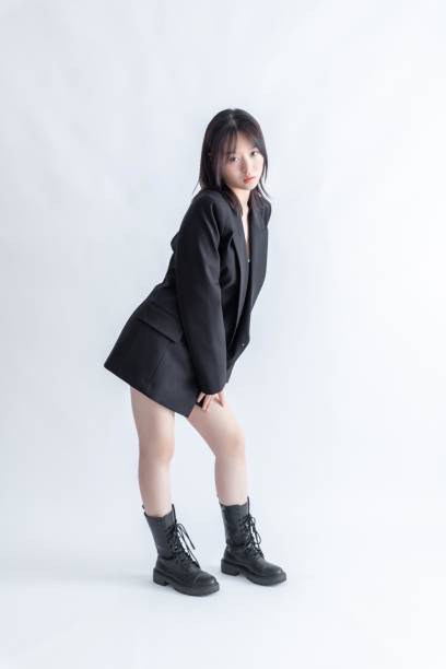 istock Asian woman in black suit and boots posing 2022682080