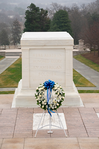 Arlington, United States – February 12, 2024: A blue ribboned wreath in front of the Tomb of the Unknown Soldier at Arlington National Cemetery