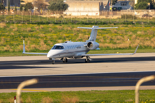 Luqa, Malta - February 3, 2024: Ryanair Learjet 45 (REG: M-ABEU) turning mid runway for take off.