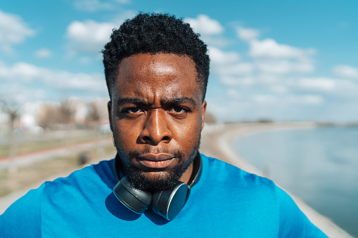 The portrait unveils a young African American man's unspoken anger, his steely gaze and tightly pressed lips a silent testament to the storm of emotions raging within