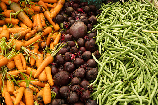 Fresh different vegetables, green bean, beetroot, pepper, carrot on market as background. Organic texture. Local food and vegetables. Agriculture. Close up.