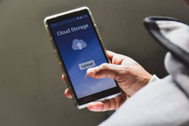 istock Person using his smartphone to upload and backup files to online storage or cloud storage service. 2022711103