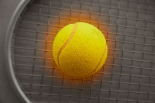 holding tennis ball