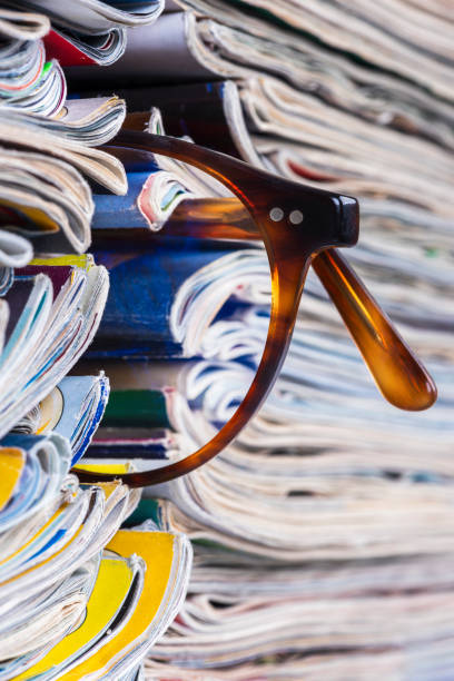 istock Newspapers and magazines and reading glasses 2022720570