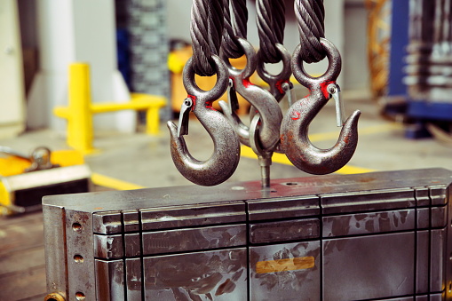 Chain hook of overhead crane and mold on floor factory.