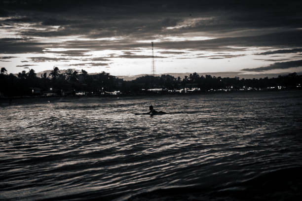 Silhouette of surfer in the evening.