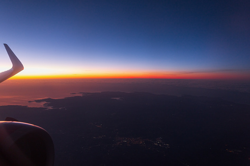 Amazing night sky after sunset from airplane porthole. Air travel