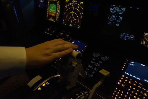 Captain hand hovers over engine control lever closeup. Pilot ready to make precise adjustments to maintain stability and efficiency