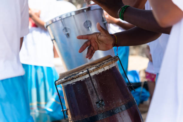 Salvador, Bahia, Brazil - February 02, 2024: Members of Candomble are seen playing percussion instruments during the party for Iemanja on Rio Veremlho beach in the city of Salvador, Bahia.