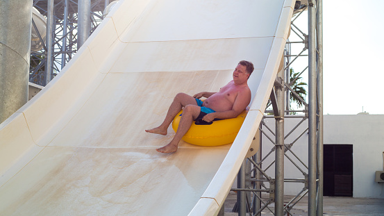Fast descent on a water slide from great height.