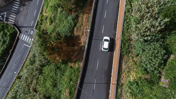 istock Asphalt road with white car, air view 2022774614