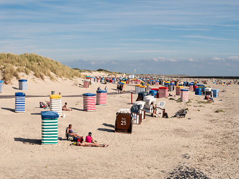 People with beach chairs and tents on south beach of East Frisian island Borkum, Lower Saxony, Germany