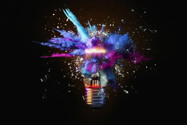 Photo of Creative colored light bulb explosion with shards and paint, a creative idea. Think different, concept. Business, ideas and the discovery of new technology