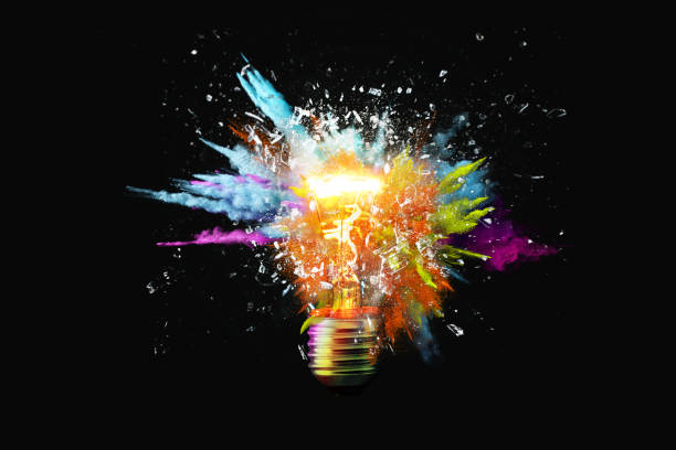 creative light bulb explodes with colorful paint splashes and shards of glass on a black background. think differently creative idea concept. dry paint splatter. brainstorm and think - idée photos et images de collection