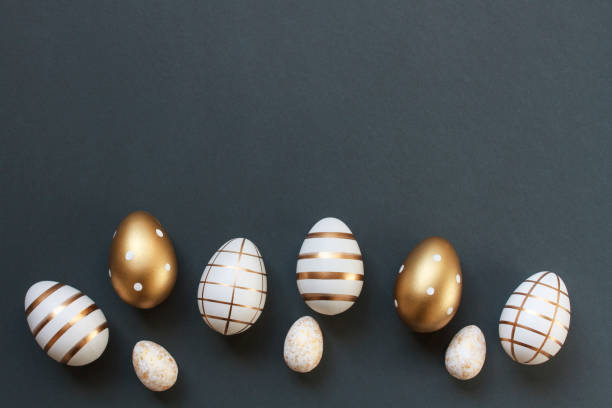 istock Luxury Easter eggs decorated with gold arranged in a semicircle on dark gray blue background with copy space 2022781624