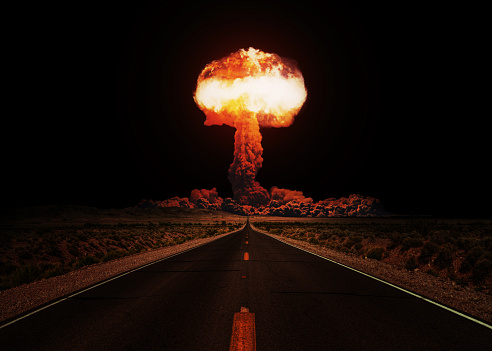 Terrible explosion of a nuclear bomb with a mushroom with road at night. Hydrogen bomb test. Nuclear catastrophe. Way to nuclear war
