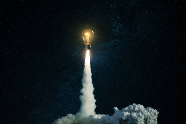 istock Creative burning light bulb rocket with blast and clouds of smoke successfully takes off into the starry sky. Creative idea, concept. Generation of new thoughts and ideas. Science and technology. 2022784789