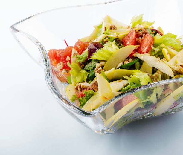 Plate with tasty grapefruit salad on white background