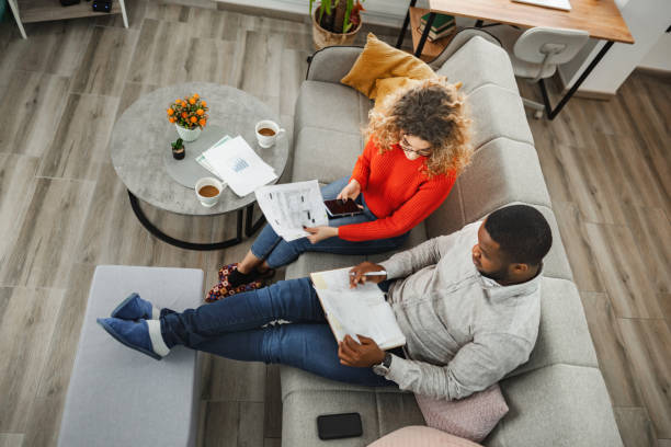 istock Multiracial couple calculating home finances while sitting on the sofa 2022810800