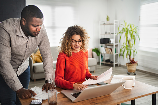 Multiracial couple doing home finances together