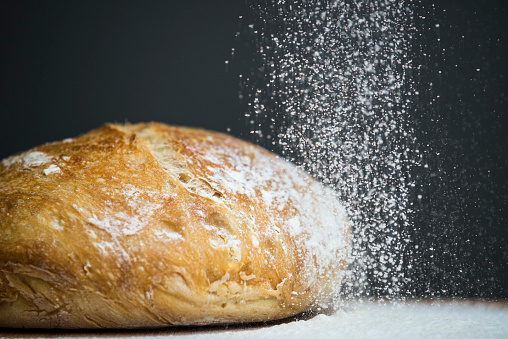 Bread with falling flour background.