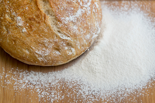 Bread with falling flour background.